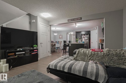 Living area with a textured ceiling and light wood finished floors - 21971 91 Avenue Nw, Edmonton, AB - Indoor Photo Showing Living Room