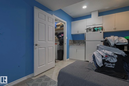 Kitchen featuring freestanding refrigerator and light countertops - 21971 91 Avenue Nw, Edmonton, AB - Indoor