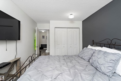 Bedroom featuring a closet and a textured ceiling - # 3 13450 Fort Road, Edmonton, AB - Indoor Photo Showing Bedroom