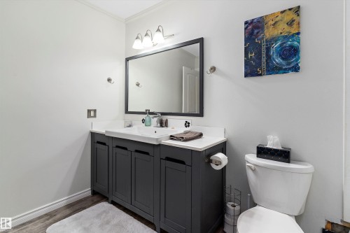 Bathroom with vanity and wood finished floors - # 3 13450 Fort Road, Edmonton, AB - Indoor Photo Showing Bathroom