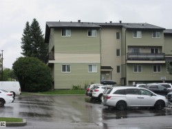 View of building exterior with uncovered parking - 