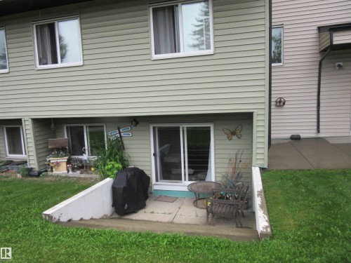 Rear view of house with a patio and a yard - # 3 13450 Fort Road, Edmonton, AB - Outdoor With Deck Patio Veranda With Exterior