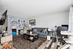 Living room featuring a textured ceiling and wood finished floors - 