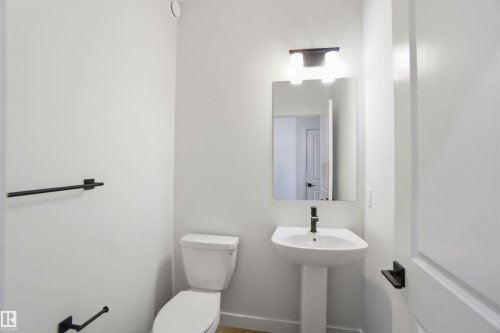Half bathroom featuring toilet and baseboards - 19348 29 Avenue, Edmonton, AB - Indoor Photo Showing Bathroom