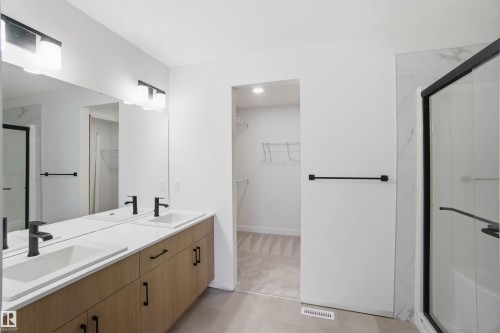 Full bathroom with a marble finish shower, double vanity, and a spacious closet - 19348 29 Avenue, Edmonton, AB - Indoor Photo Showing Bathroom