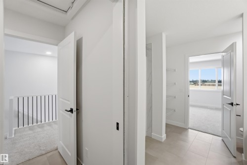 Hallway featuring light carpet and light tile patterned floors - 19348 29 Avenue, Edmonton, AB - Indoor Photo Showing Other Room