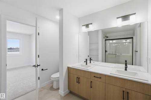 Full bath with double vanity and a shower stall - 19348 29 Avenue, Edmonton, AB - Indoor Photo Showing Bathroom