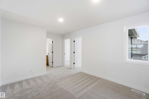 Unfurnished room with baseboards and light carpet - 19348 29 Avenue, Edmonton, AB - Indoor Photo Showing Other Room