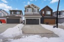 Craftsman house with board and batten siding, an attached garage, and driveway - 19348 29 Avenue, Edmonton, AB  - Outdoor With Facade 