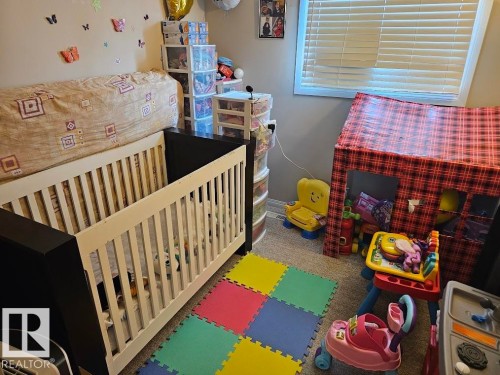 Bedroom featuring a crib and carpet - 223 Kaskitayo Crest, Edmonton, AB - Indoor Photo Showing Other Room