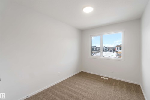 Carpeted empty room with baseboards - 18912 28 Avenue, Edmonton, AB - Indoor Photo Showing Other Room