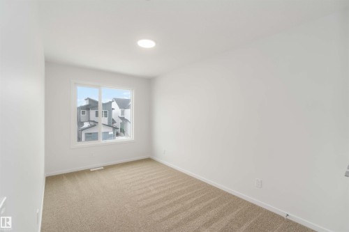 Empty room with light carpet and baseboards - 18912 28 Avenue, Edmonton, AB - Indoor Photo Showing Other Room