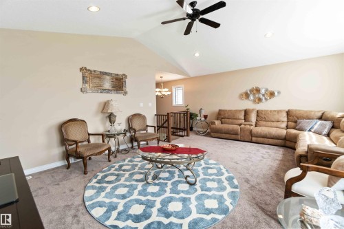 Living area with ceiling fan, a chandelier, and carpet - 6116 53 Avenue, Beaumont, AB - Indoor Photo Showing Living Room