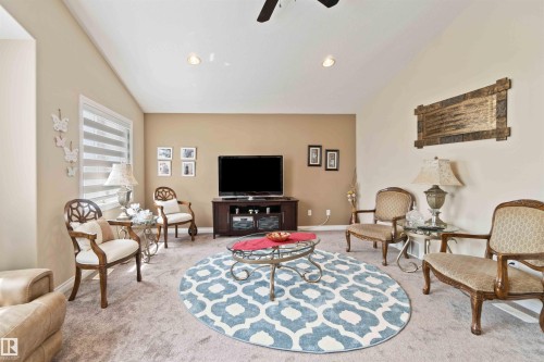 Living room featuring lofted ceiling, ceiling fan, light colored carpet, and recessed lighting - 6116 53 Avenue, Beaumont, AB - Indoor Photo Showing Living Room