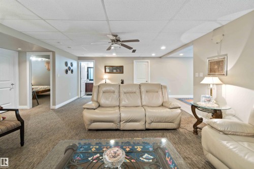 Living area with recessed lighting, a paneled ceiling, ceiling fan, and carpet flooring - 6116 53 Avenue, Beaumont, AB - Indoor Photo Showing Living Room