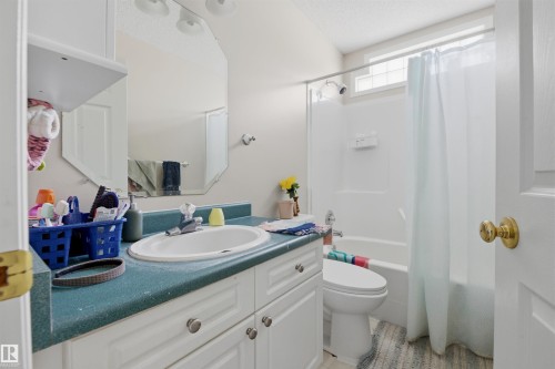 Full bath with vanity, a textured ceiling, and shower / bath combo - 444 Breckenridge Lane Nw, Edmonton, AB - Indoor Photo Showing Bathroom