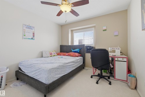 Bedroom featuring light colored carpet, a ceiling fan, and a desk - 444 Breckenridge Lane Nw, Edmonton, AB - Indoor Photo Showing Bedroom