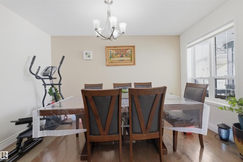 Dining room with a chandelier and hardwood / wood-style flooring - 444 Breckenridge Lane Nw, Edmonton, AB - Indoor Photo Showing Dining Room