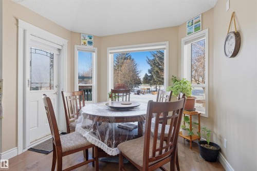 Dining space with light wood finished floors and a fireplace - 444 Breckenridge Lane Nw, Edmonton, AB - Indoor Photo Showing Dining Room