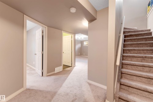 Staircase with baseboards and carpet flooring - 1157 37 Avenue, Edmonton, AB - Indoor Photo Showing Other Room