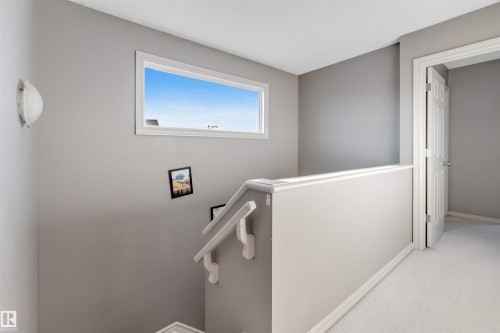 Staircase with carpet floors and baseboards - 1157 37 Avenue, Edmonton, AB - Indoor Photo Showing Other Room