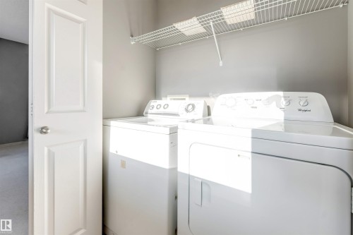 Laundry area with separate washer and dryer and carpet floors - 1157 37 Avenue, Edmonton, AB - Indoor Photo Showing Laundry Room