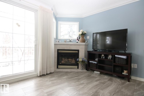 308 17150 94A Avenue, Edmonton, AB - Indoor Photo Showing Living Room With Fireplace
