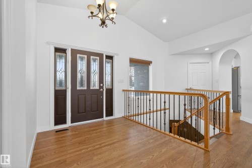 Entryway with wood finished floors, lofted ceiling, arched walkways, and hanging lights - 19 Country Lane, Stony Plain, AB - Indoor Photo Showing Other Room