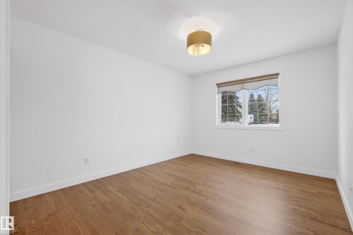 Unfurnished room featuring wood finished floors and baseboards - 19 Country Lane, Stony Plain, AB - Indoor Photo Showing Other Room