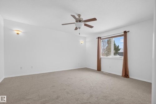 Carpeted spare room with ceiling fan and baseboards - 19 Country Lane, Stony Plain, AB - Indoor Photo Showing Other Room
