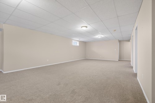 Basement with a paneled ceiling and light carpet - 19 Country Lane, Stony Plain, AB - Indoor