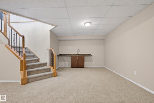 Finished below grade area featuring a paneled ceiling and light carpet - 19 Country Lane, Stony Plain, AB - Indoor Photo Showing Other Room