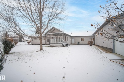 Snow covered property featuring a wooden deck - 19 Country Lane, Stony Plain, AB - Outdoor