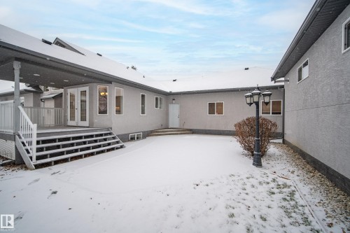 Snow covered back of property with french doors - 19 Country Lane, Stony Plain, AB - Outdoor