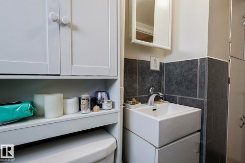 Half bathroom with vanity and tile walls - 4906 48 Street, Thorsby, AB - Indoor Photo Showing Bathroom