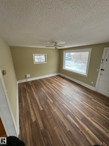 This room features wide plank flooring, light-colored walls, and a ceiling fan - 4906 48 Street, Thorsby, AB - Indoor Photo Showing Other Room
