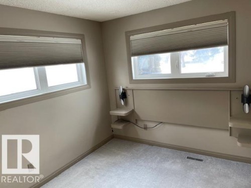 Unfurnished room featuring light carpet and a textured ceiling - 11 Campbell, Stony Plain, AB - Indoor Photo Showing Other Room