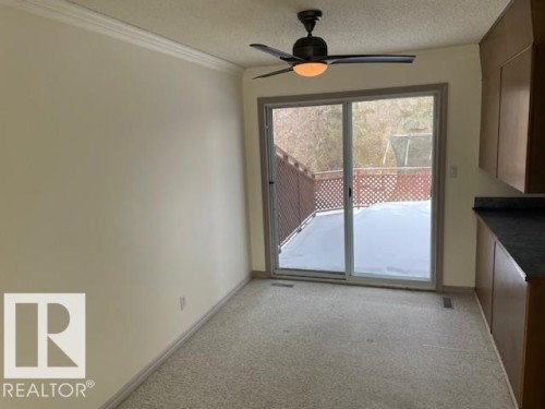 Unfurnished dining area featuring light colored carpet, a ceiling fan, a textured ceiling, and ornamental molding - 11 Campbell, Stony Plain, AB - Indoor Photo Showing Other Room