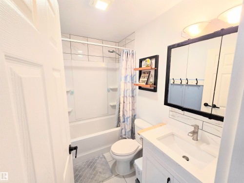 Full bathroom with vanity, shower / tub combo with curtain, and light tile patterned floors - 80 Amberly Crest, Edmonton, AB - Indoor Photo Showing Bathroom