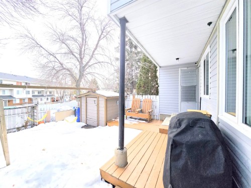 Wooden terrace with a storage shed and area for grilling - 80 Amberly Crest, Edmonton, AB - Outdoor With Exterior