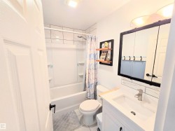Full bathroom with vanity, shower / tub combo with curtain, and light tile patterned floors - 