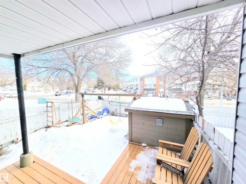 Wooden deck featuring a fenced backyard and a playground - 80 Amberly Crest, Edmonton, AB - Outdoor With Deck Patio Veranda