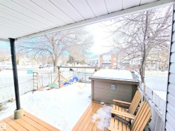 Wooden deck featuring a fenced backyard and a playground - 