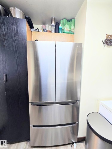 Kitchen featuring freestanding refrigerator and light wood-style flooring - 2 4403 Riverbend Road, Edmonton, AB - Indoor