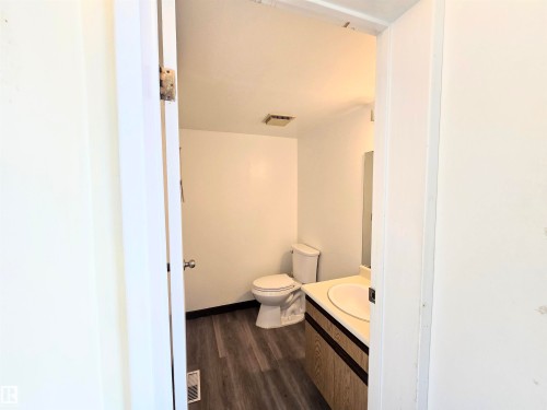 Bathroom featuring vanity and dark wood-type flooring - 2 4403 Riverbend Road, Edmonton, AB - Indoor Photo Showing Bathroom