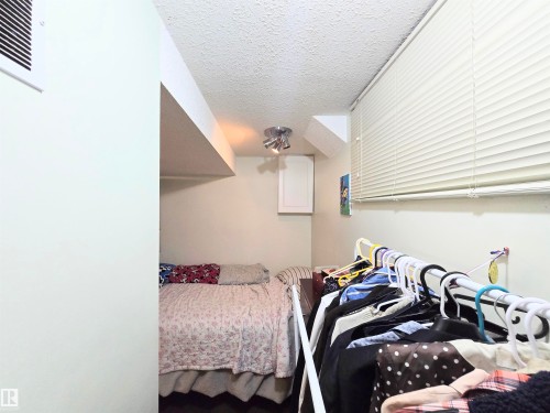 Bedroom featuring a textured ceiling - 2 4403 Riverbend Road, Edmonton, AB - Indoor Photo Showing Bedroom