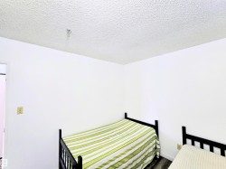 Bedroom featuring a textured ceiling - 
