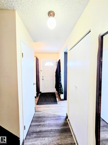 Corridor featuring wood finished floors and a textured ceiling - 2 4403 Riverbend Road, Edmonton, AB - Indoor Photo Showing Other Room