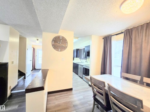 Dining room with a textured ceiling and light wood-type flooring - 2 4403 Riverbend Road, Edmonton, AB - Indoor