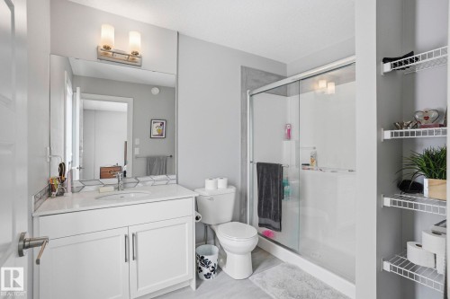 Full bathroom featuring vanity, a stall shower, and a textured ceiling - 90 1010 Rabbit Hill Road, Edmonton, AB - Indoor Photo Showing Bathroom